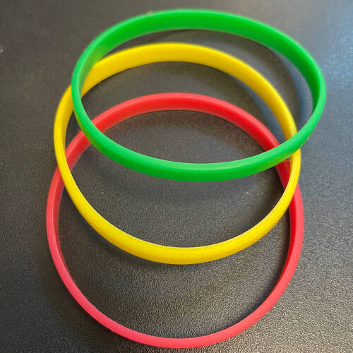 A photo of red, yellow, and green bracelets.